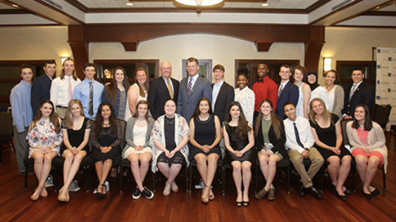 A group of scholarship recipients and SBO employees posing for the camera at an event